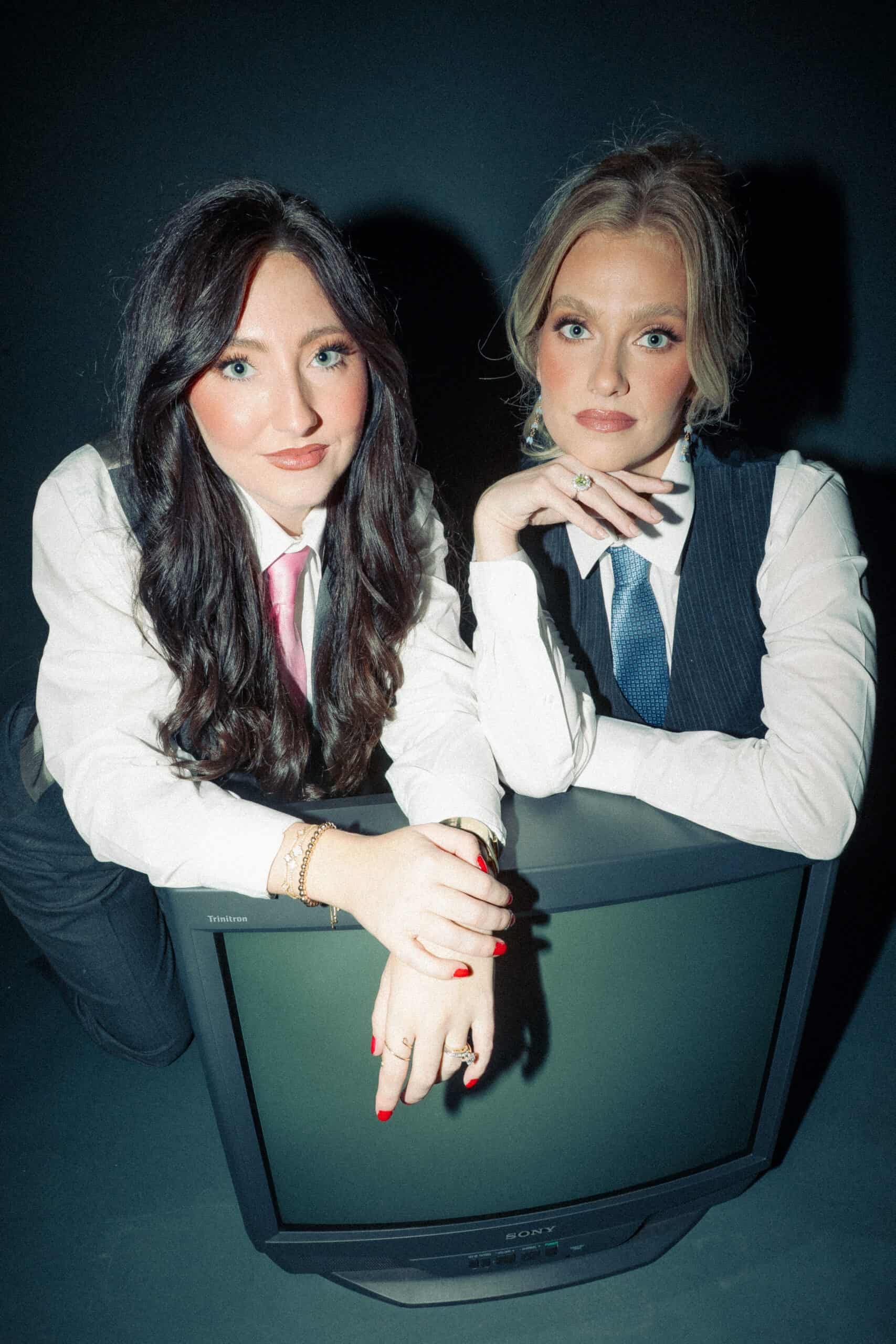 Women working together on a creative project with a vintage TV.