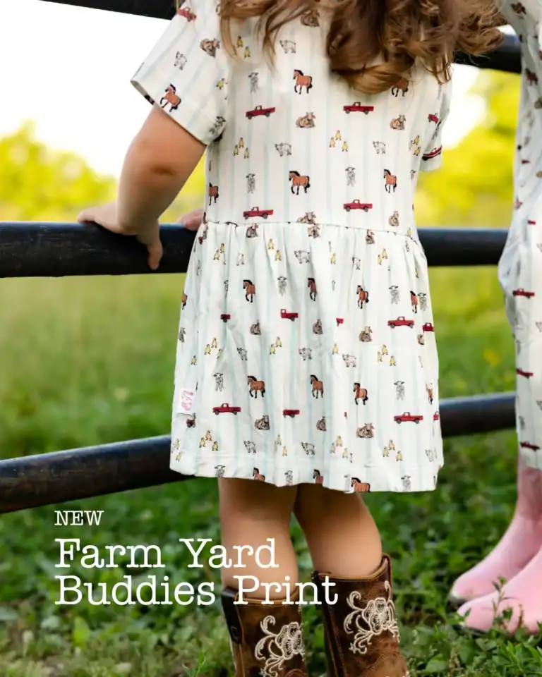 Remi & Capri ad: new Farm Yard Buddies print dress by a fence