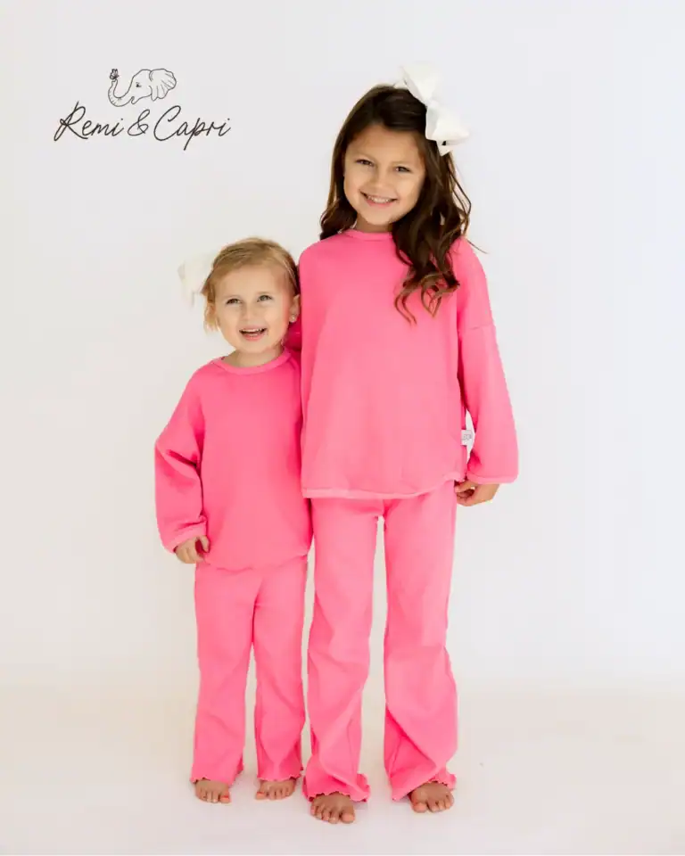 Remi & Capri ad: two smiling girls in matching bright pink lounge sets